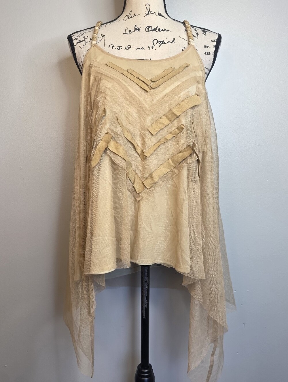 Cream mesh asymmetrical top with cut out details and beaded straps. Size: L Y2k